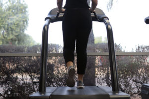 Person running on treadmill returning to exercise